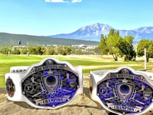 Two white championship belts in the golf course