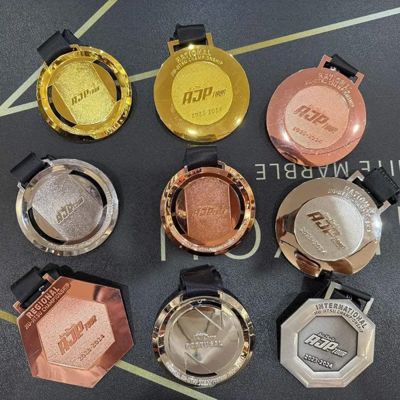 A collection of nine colorful AJP tour medals displayed together, showcasing various designs and colors.