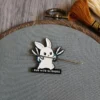 Soft enameled white rabbit with scissors in hand and I RUN WITH SCISSORS written underneath