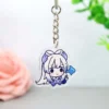 Llavero acrílico con un personaje de Genshin Impact, sosteniendo delicadamente una flor azul.