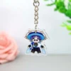 Un llavero acrílico con un personaje de Genshin Impact, adornado con un elegante sombrero.