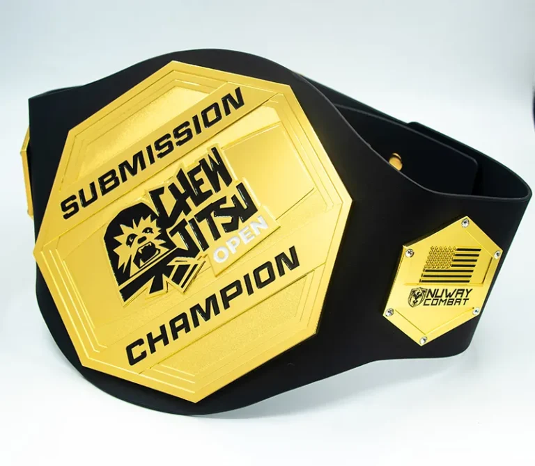 A black and gold belt featuring the words "Submission Champion" prominently displayed on its surface.