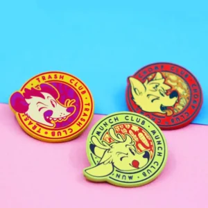 Three colorful pins displaying the words "anime club" in bold letters, showcasing vibrant designs and styles.