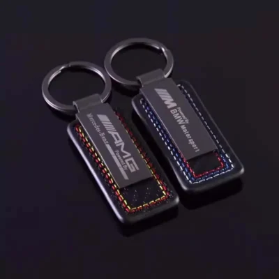 Two key chains featuring the Mercedes AMG logo, showcasing a sleek and stylish design for automotive enthusiasts.