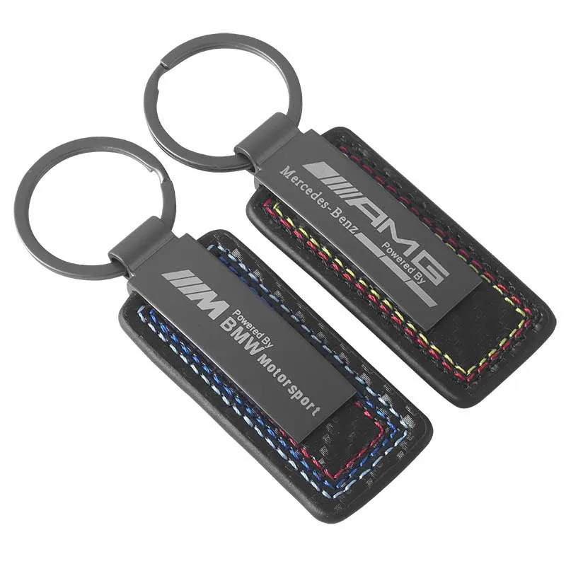 Two key chains featuring the Mercedes AMG logo, showcasing sleek design and automotive elegance.