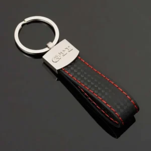 A black and red keychain featuring a prominent silver logo, showcasing a stylish and modern design.