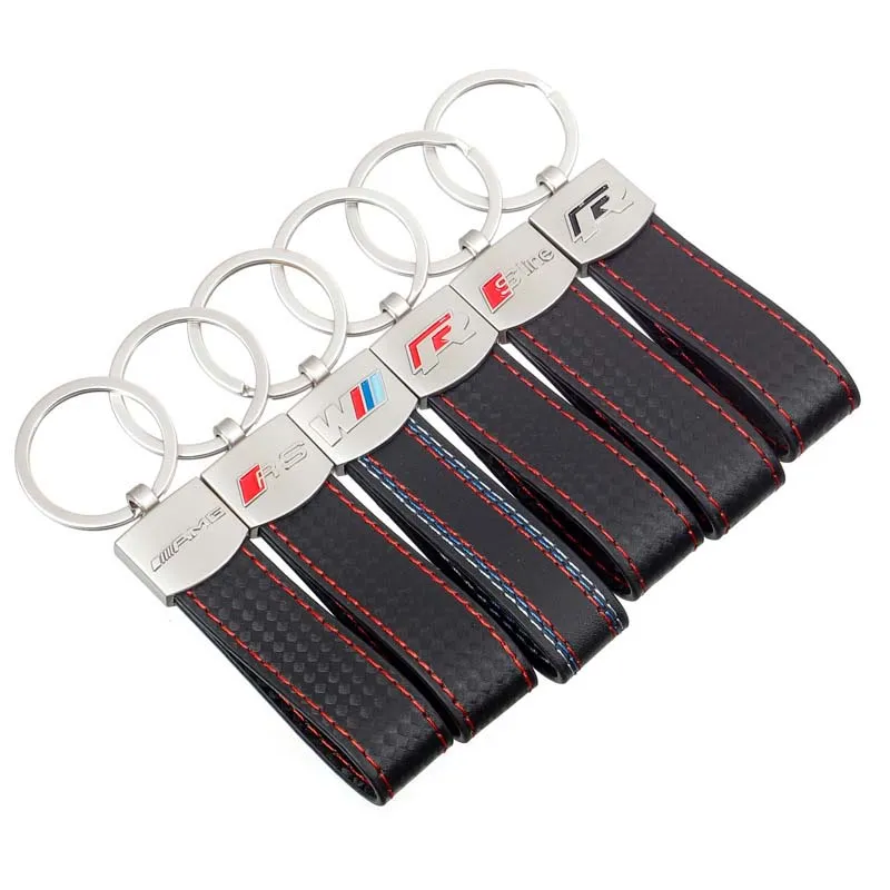 Four distinct key chains featuring the BMW logo, showcasing various designs and colors.