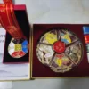 One hiking medal on the left and five combinable hiking medals with ribbons on the right in a medal gift box