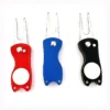 three golf divot tools arranged together on a neutral background.