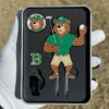 A bear in a green shirt holds a golf club, with a golf divot tool and ball marker nearby.
