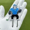 A golfer grips a divot tool shaped like a gorilla, showcasing a unique blend of sport and wildlife.