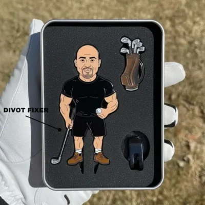A golf pin featuring a man in black attire, alongside a golf divot tool and ball marker.