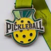 A medal featuring a pickleball design, symbolizing achievement in the sport of pickleball.