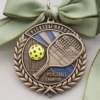 Close-up of a pickleball champion medal, showcasing its intricate design and representing excellence in pickleball.