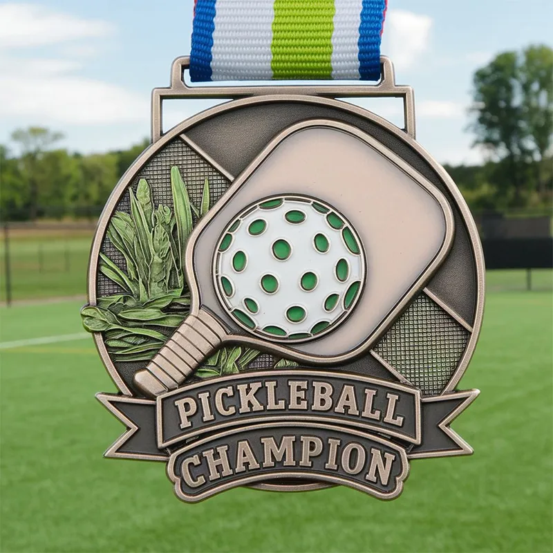 A shiny pickleball champion medal featuring a detailed design, symbolizing victory in the sport of pickleball.