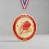 A shiny red and gold medal inscribed with "Pickleball Champion," symbolizing athletic achievement.