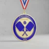 Pickleball medal featuring a blue ribbon with red and white stripes, symbolizing achievement in the sport.
