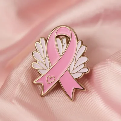 A pink ribbon pin with a heart, signifying love and support for important health and social causes.