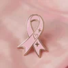 A pink ribbon pin with a heart, signifying love and support for important health and social causes.
