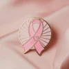 A pink ribbon pin with a heart, signifying love and support for important health and social causes.