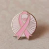 A pink ribbon pin with a heart, signifying love and support for important health and social causes.