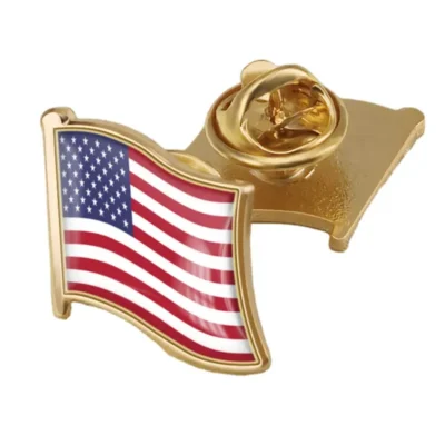 A gold pin featuring the United States flag, symbolizing patriotism and national pride.