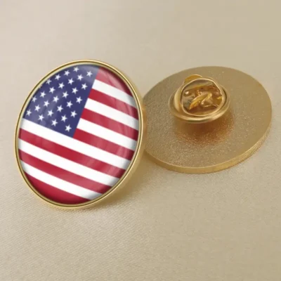 A gold pin featuring the United States flag, symbolizing patriotism and national pride.