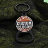 Custom logo metal bottle opener keychain with black finish and round enamel logo design, promotional keyring gift