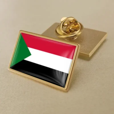 Gold lapel pin featuring the flag of Sudan, symbolizing national pride and identity.