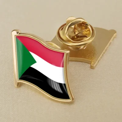 Gold lapel pin featuring the flag of Sudan, symbolizing national pride and identity.