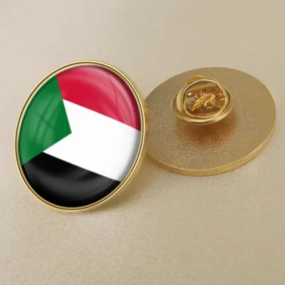 Gold lapel pin featuring the flag of Sudan, symbolizing national pride and identity.