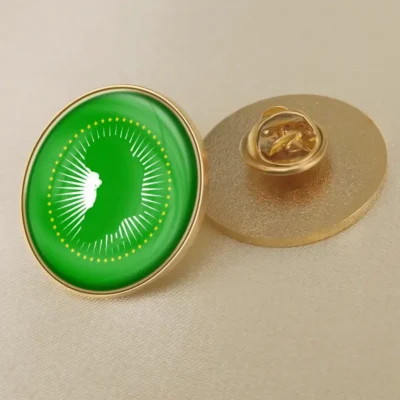 Green and gold pin featuring the African Union flag, ideal for wholesale distribution.