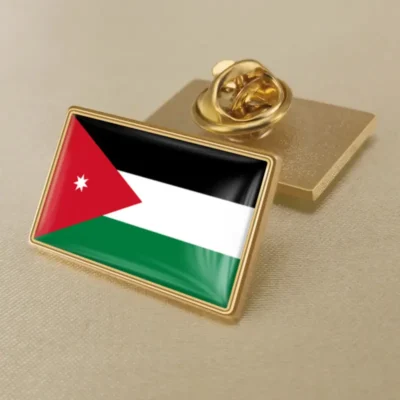 A lapel pin featuring the flag of Jordan, showcasing its vibrant colors and design for patriotic display.