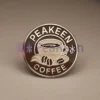 Custom enamel pin featuring a peakeen coffee design, perfect for coffee lovers and collectors.