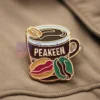 Custom enamel pin featuring a peakeen coffee design, perfect for coffee lovers and collectors.