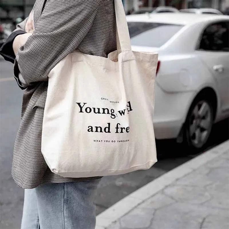 Custom tote bag featuring the phrase "young, wild and free" in a stylish design, perfect for casual outings.