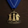 Gold chess tournament medal featuring a cut-out chess piece design.