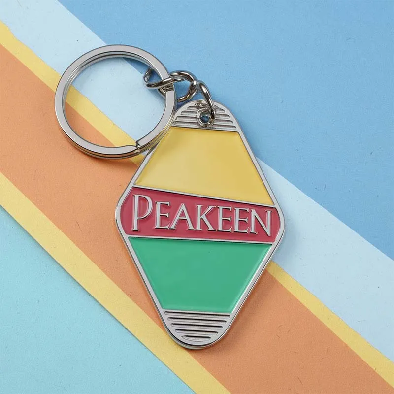 Custom hotel keychain featuring the word "peakeen" in a stylish design, perfect for guests and collectors alike.