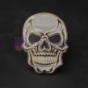 Spilla personalizzata con teschio d'oro e occhi neri, che rappresenta un accessorio unico ed elegante per qualsiasi abbigliamento.