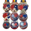 A collection of custom table tennis medals featuring colorful ping pong balls on each medal's surface.