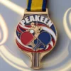 Custom table tennis medal featuring a ping pong ball and a tennis racket design.