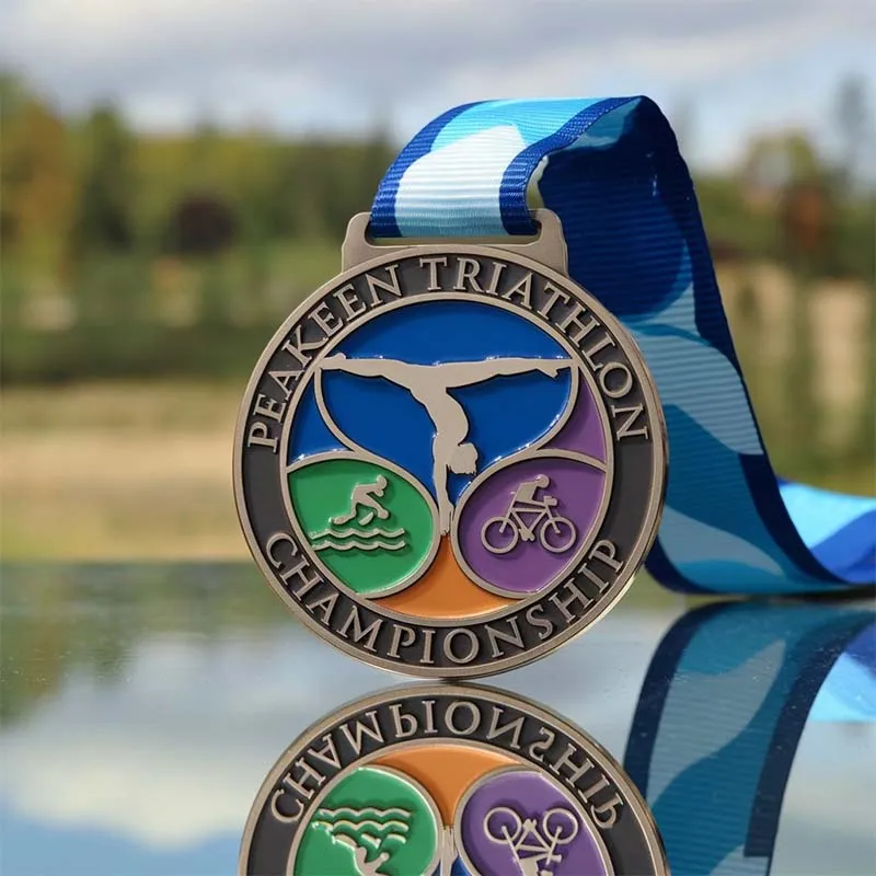 Custom triathlon medal featuring a blue ribbon, symbolizing achievement and athletic excellence.