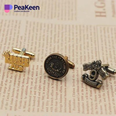 Three cufflinks featuring the word "peakeen" elegantly displayed together.