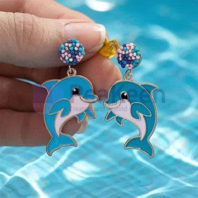 Custom soft enamel dolphin earrings featuring vibrant blue and pink beads, perfect for ocean lovers and unique jewelry enthusiasts.