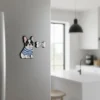 A colorful dog magnet attached to a refrigerator in a cozy kitchen setting.