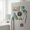 A refrigerator adorned with colorful magnets spelling "California," showcasing a collection of country-themed fridge magnets.
