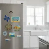 A kitchen refrigerator adorned with various state souvenir magnets, showcasing a colorful collection of travel memories.