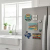 A refrigerator in a kitchen decorated with state souvenir magnets, highlighting different locations and travel experiences.