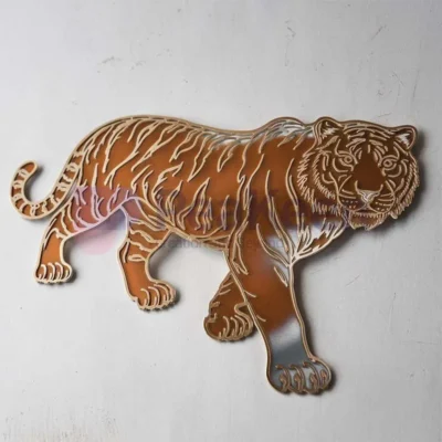 A tiger wall mirror featuring custom metal stickers, set against a rich brown background.