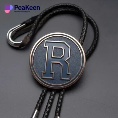 A black and silver lanyard featuring the letter 'R', designed as a custom metal bolo tie accessory.